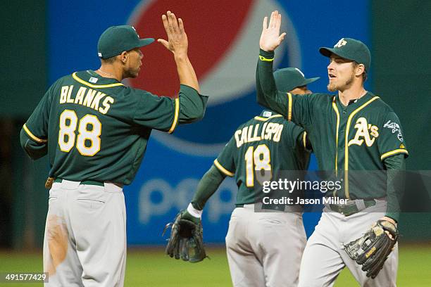 Kyle Blanks celebrates with Josh Reddick of the Oakland Athletics after the Athletics defeated the Cleveland Indians at Progressive Field on May 16,...