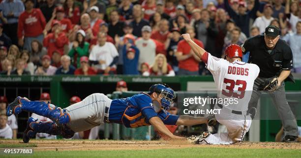 Washington Nationals pinch hitter Greg Dobbs is tagged out at home plate by New York Mets catcher Anthony Recker during the seventh inning of their...