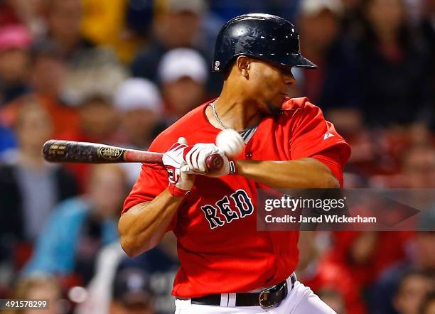 Xander Bogaerts of the Boston Red Sox is hit in the hand by a pitch against the Detroit Tigers during the game at Fenway Park on May 16, 2014 in...