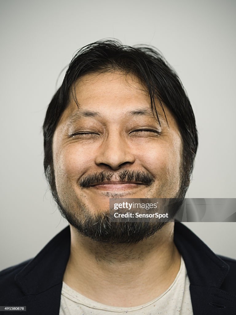 Portrait of a happy japanese man looking at camera