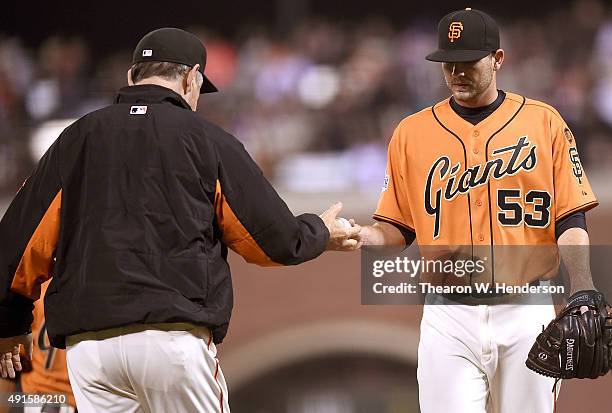 Manager Bruce Bochy of the San Francisco Giants takes the ball from starting pitcher Chris Heston taking him out of the game against the Colorado...