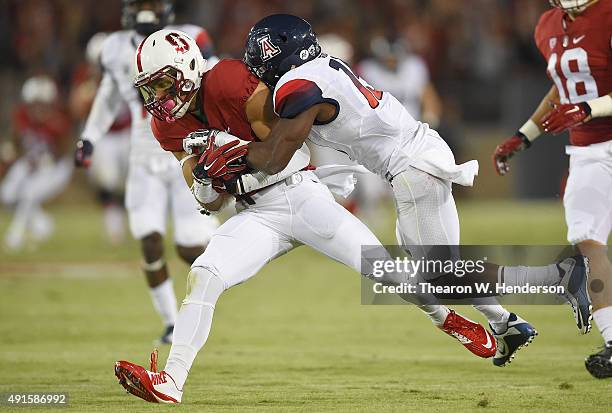 Michael Rector of the Stanford Cardinal gets tackled by DaVonte' Neal of the Arizona Wildcats in the second quarter of an NCAA football game at...