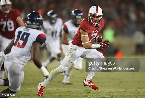 Michael Rector of the Stanford Cardinal runs with the ball while pursued by DaVonte' Neal of the Arizona Wildcats during the third quarter of an NCAA...