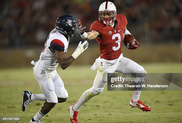 Michael Rector of the Stanford Cardinal runs with the ball while pursued by DaVonte' Neal of the Arizona Wildcats during the third quarter of an NCAA...