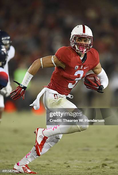 Michael Rector of the Stanford Cardinal runs with the ball while pursued by DaVonte' Neal of the Arizona Wildcats during the third quarter of an NCAA...