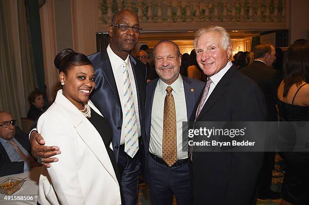 Tameka Beamon, her father and former track and field athlete Bob Beamon pose with Nick Buoniconti at the 30th Annual Great Sports Legends Dinner to...