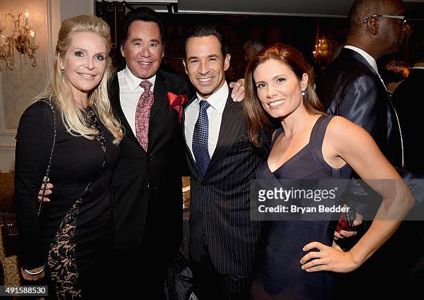 Kathleen McCrone, Wayne Newton, Helio Castroneves and Adriana Henao attend the 30th Annual Great Sports Legends Dinner to benefit The Buoniconti Fund...