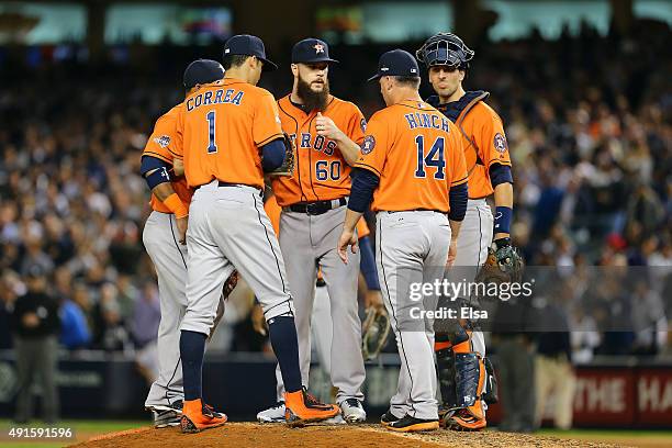 Hinch of the Houston Astros tallks with Dallas Keuchel of the Houston Astros on the mound during the sixth inning against the New York Yankees during...