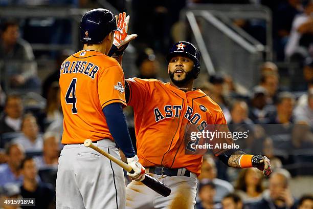 Jonathan Villar of the Houston Astros celebrates with George Springer after scoring a run on Jose Altuve single to left against Dellin Betances of...