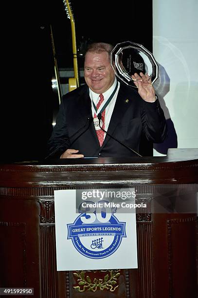 Former racing driver and honoree, Chip Ganassi poses with an award onstage at the 30th Annual Great Sports Legends Dinner to benefit The Buoniconti...