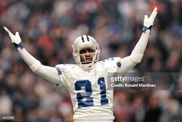 Deion Sanders of the Dallas Cowboys celebrates on the field during the game against the Miami Dolphins at the Texas Stadium in Irving, Texas. The...