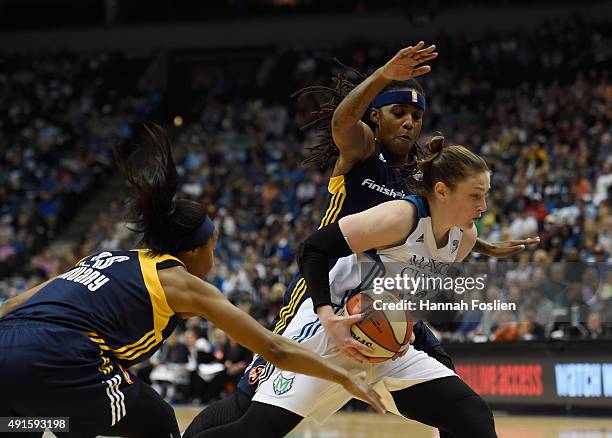 Briann January and Shavonte Zellous of the Indiana Fever defend against Lindsay Whalen of the Minnesota Lynx during the second quarter in Game Two of...