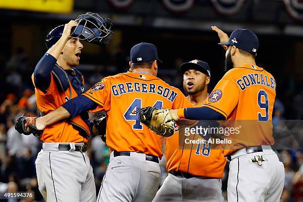 Luke Gregerson of the Houston Astros celebrates with his teammates Jason Castro, Luis Valbuena and Marwin Gonzalez after defeating the New York...
