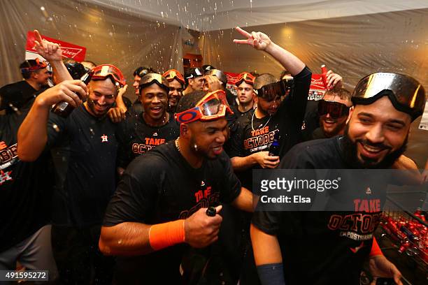 The Houston Astros celebrate in their locker room after defeating the New York Yankees in the American League Wild Card Game at Yankee Stadium on...