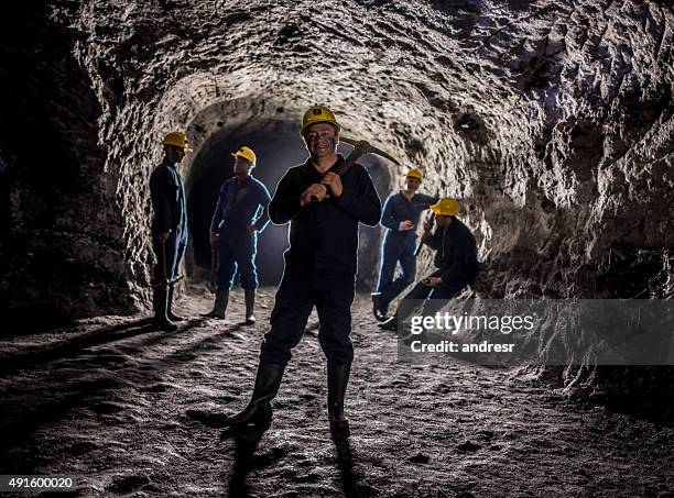 man working at a mine with a group - miner pick stock pictures, royalty-free photos & images