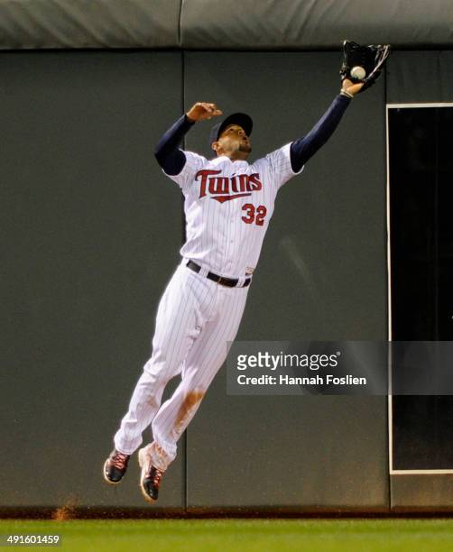 Aaron Hicks of the Minnesota Twins makes a catch in center field of the ball hit by Mike Zunino of the Seattle Mariners during the eighth inning of...