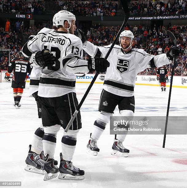 Anze Kopitar, Kyle Clifford and Jake Muzzin of the Los Angeles Kings celebrate Koipitar's second period goal against the Anaheim Ducks in Game Seven...