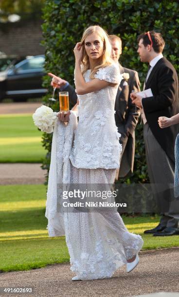 Poppy Delevingne is seen at Poppy Delevingne and James Cook's wedding reception held in Kensington Palace Gardens on May 16, 2014 in London, England.