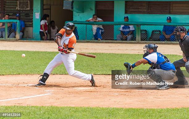 Cuban baseball classic: Industriales vs Villa Clara in the stadium Sandino. Ariel Borrero bats for Villa Clara,Frank Morejon acts like a catcher for...