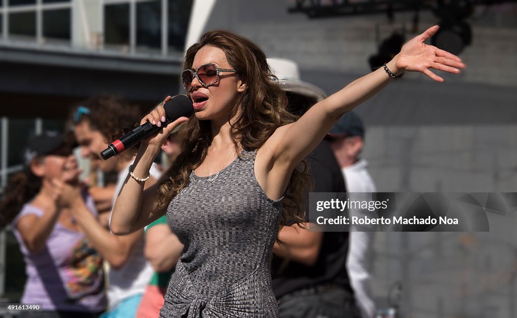 Vivianna Castel singing on stage and waving her hand at...