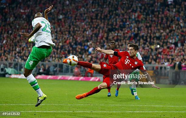 Robert Lewandowski of Bayern Munich scores his 5th goal with a sideways scissor-kick during the Bundesliga match between FC Bayern Muenchen and VfL...