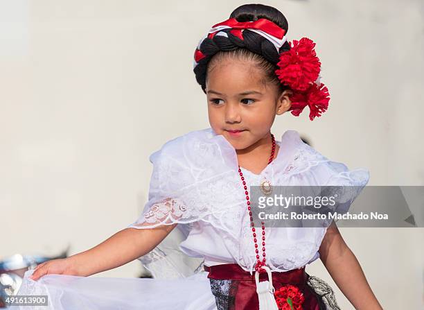 Young girl in white dress performing the Flamenco folk dance on stage at MexFest 2015 in Toronto. MexFest 2015 is celebration of all things Mexican...