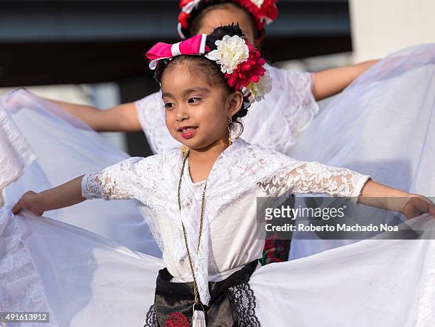 Young girls in white dress performing the Flamenco folk dance at MexFest 2015 in Toronto. MexFest 2015 is celebration of all things Mexican and the...