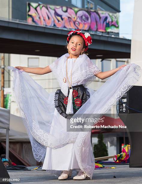 Young girl in white dress performing the Flamenco folk dance on stage at MexFest 2015 in Toronto. MexFest 2015 is celebration of all things Mexican...