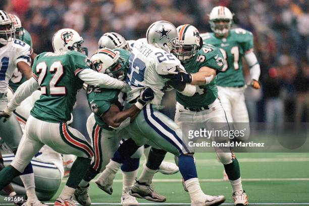 Zach Thomas of the Miami Dolphins tackles Emmitt Smith of the Dallas Cowboys at the Texas Stadium in Irving, Texas. The Cowboys defeated the Dolphins...