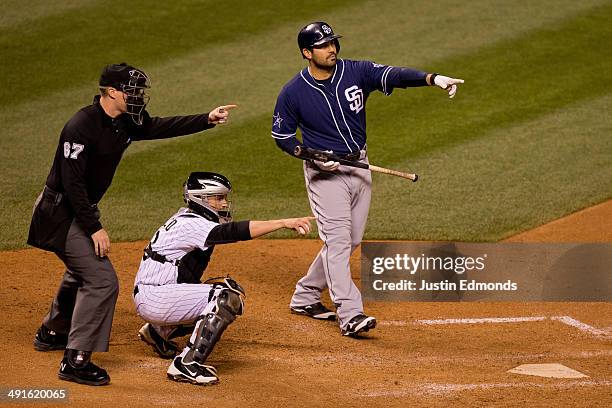 Home plate umpire Seth Buckminster asks for help on a check swing by Carlos Quentin of the San Diego Padres as catcher Jordan Pacheco of the Colorado...