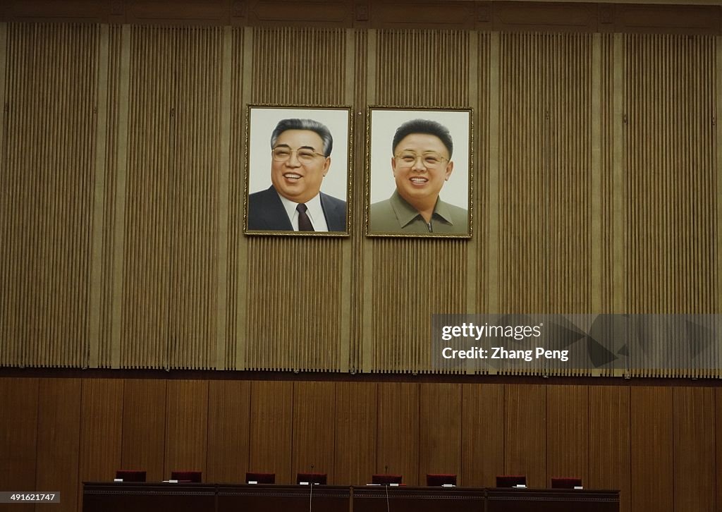 Photos of Kim Il Sung and Kim Jong-il are hung on the wall...