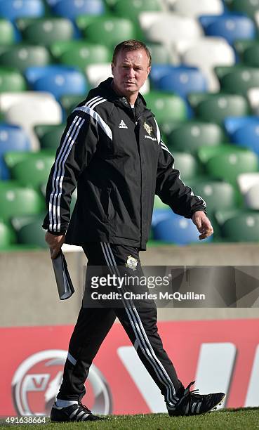 Northern Ireland manager Michael O'Neill watches on as the international football squad train at Windsor Park on October 7, 2015 in Belfast, Northern...