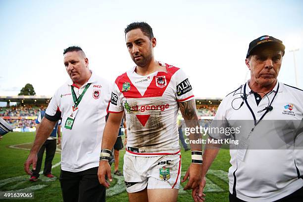 Benji Marshall of the Dragons looks dejected as he walks from the field with security guards during the round 10 NRL match between the Parramatta...