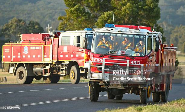 Fire trucks drive towards a bushfire in Lancefield, Victoria on October 7, 2015 near Melbourne, Australia. Victorian fire crews have been battling to...