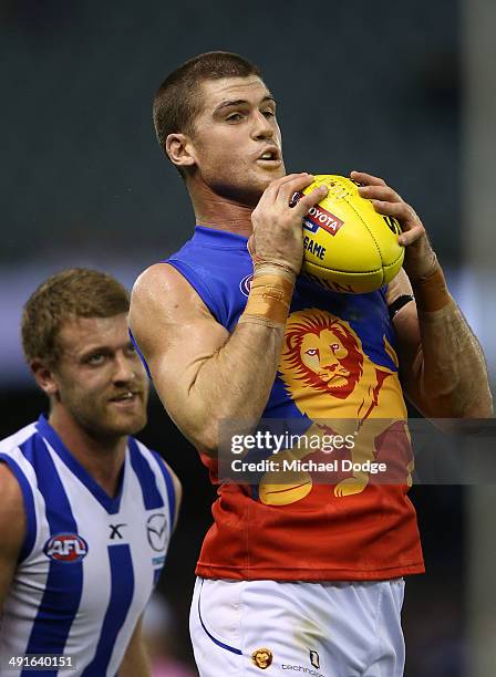 Jonathan Brown of the Lions marks the ball in front of Lachlan Hansen of the Kangaroos during the round nine AFL match between the North Melbourne...
