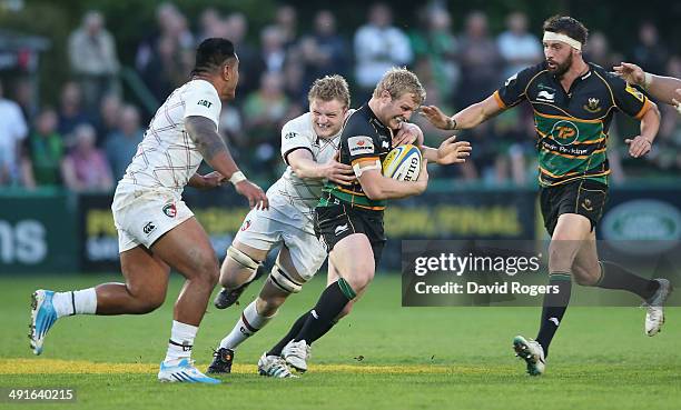 Mike Haywood of Northampton is tackled by Jamie Gibson during the Aviva Premiership semi final match between Northampton Saints and Leicester Tigers...