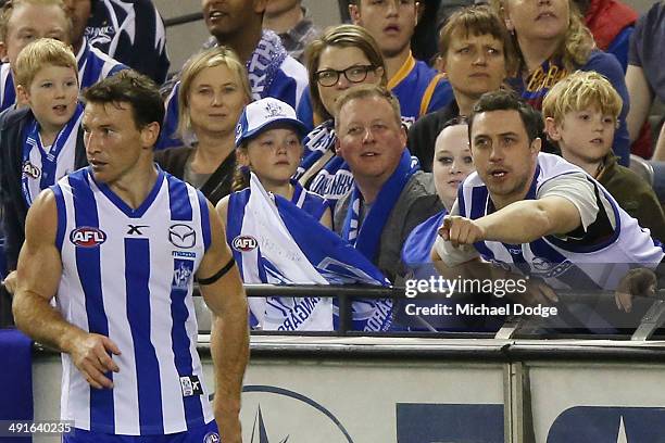 Kangaroos fan gestures to Brent Harvey of the Kangaroos during the round nine AFL match between the North Melbourne Kangaroos and the Brisbane Lions...