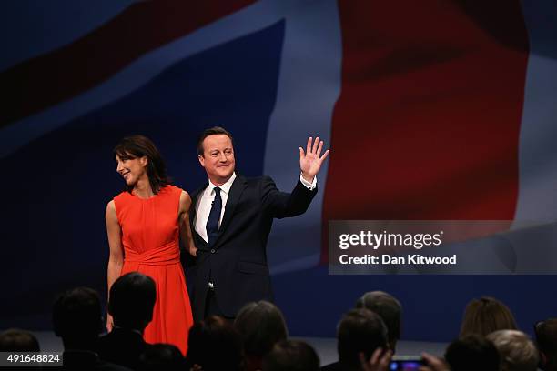 British Prime Minister David Cameron stands onstage with wife Samantha following his keynote speech to delegates on the fourth and final day of the...