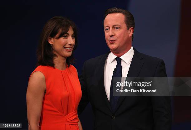 British Prime Minister David Cameron stands onstage with wife Samantha following his keynote speech to delegates on the fourth and final day of the...