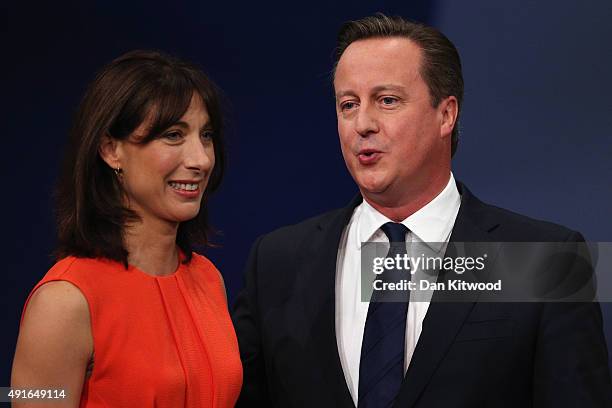 British Prime Minister David Cameron and wife Samantha Cameron stand on stage after Mr Cameron's keynote speech on the fourth and final day of the...