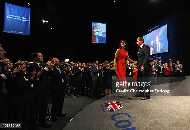 British Prime Minister David Cameron stands onstage with wife Samantha following his keynote speech to delegates on the fourth and final day of the...