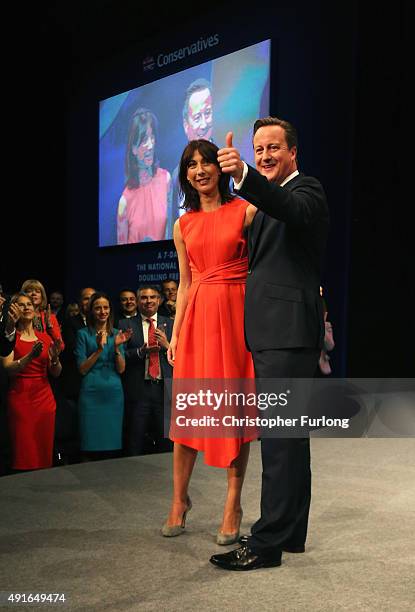 British Prime Minister David Cameron stands onstage with wife Samantha following his keynote speech to delegates on the fourth and final day of the...