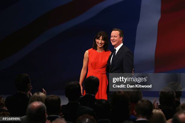 British Prime Minister David Cameron stands onstage with wife Samantha following his keynote speech to delegates on the fourth and final day of the...