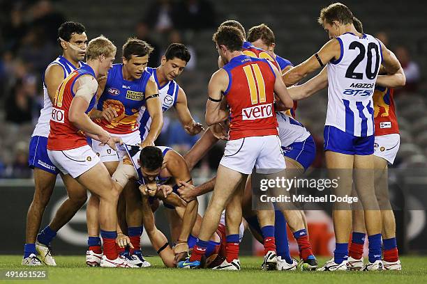 Aaron Black of the Kangaroos pins down Jordan Lisle of the Lions in a wrestle at half time during the round nine AFL match between the North...