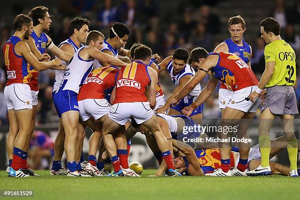 Aaron Black of the Kangaroos pins down Jordan Lisle of the Lions in a wrestle at half time during the round nine AFL match between the North...