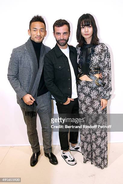 Former Football Player Hidetoshi Nakata, Fashion Designer Nicolas Ghesquiere and Actress Doona Bae pose Backstage after the Louis Vuitton show as...