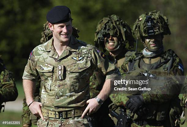 Prince Harry chats with members of the Estonian Scouts Battalion who served in Afghanistan while visiting troops participating in the "Spring Storm"...