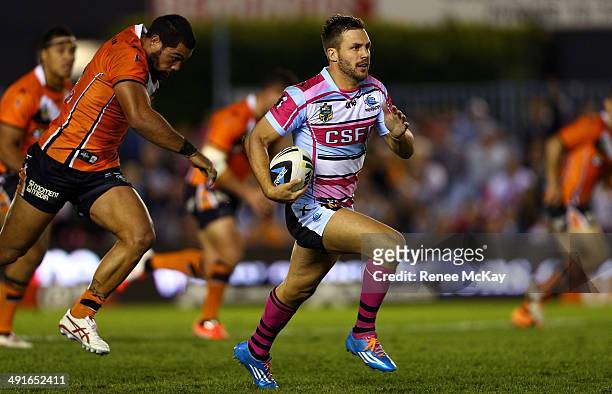 Beau Ryan of the Sharks makes a break during the round 10 NRL match between the Cronulla-Sutherland Sharks and the Wests Tigers at Remondis Stadium...