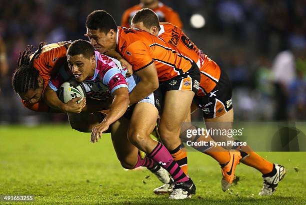 Anthony Tupou of the Sharks is tackled by Martin Taupau and Sauaso Sue of the Tigers during the round 10 NRL match between the Cronulla-Sutherland...