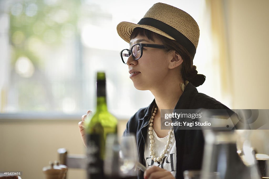 Woman sitting at table in cafe with friends